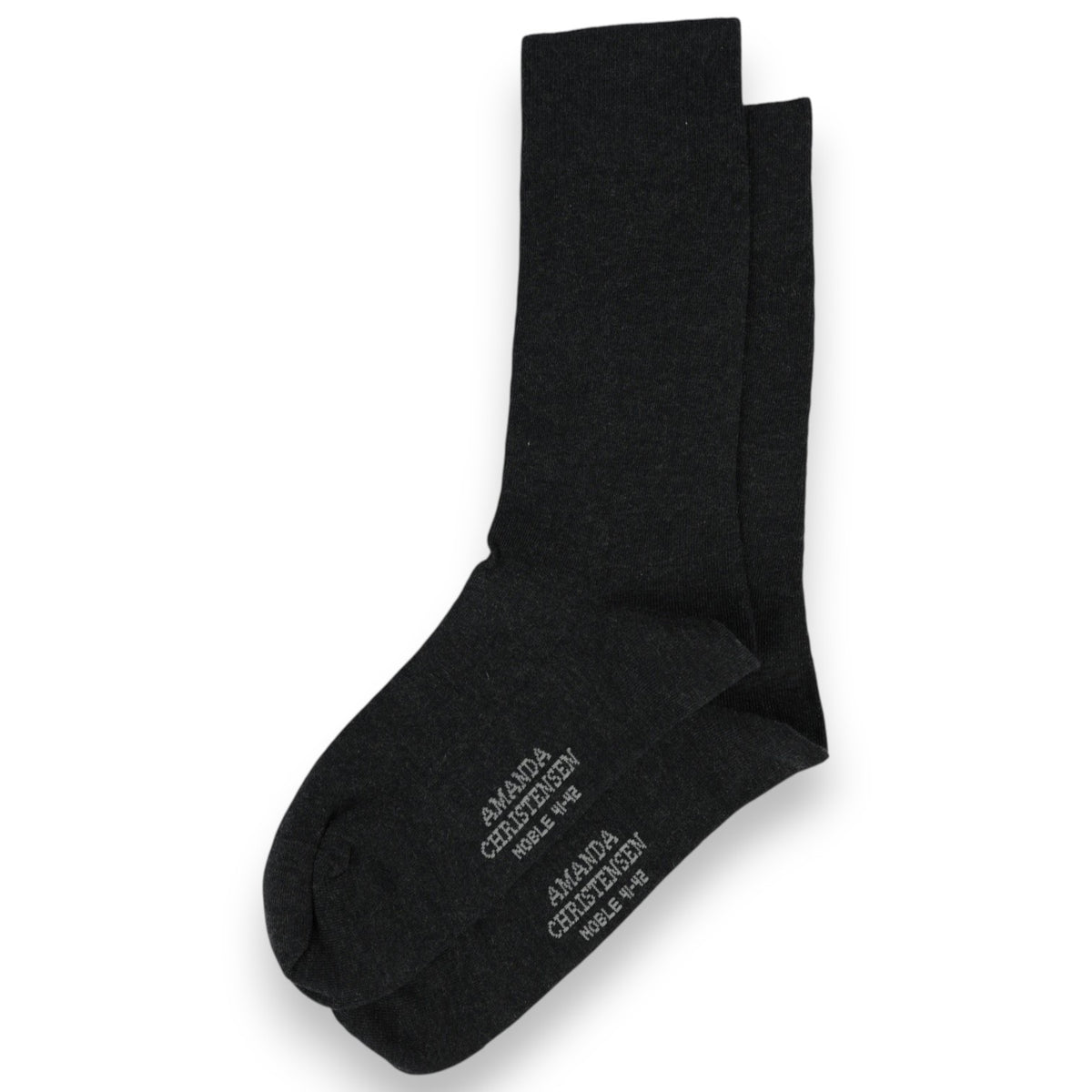 A pair of anthracite melange mid-calf socks from AMANDA CHRISTENSEN, crafted in a luxurious cotton and cashmere blend with white text on the soles, arranged on a white background—these NOBLE socks showcase timeless style and meticulous attention to detail.