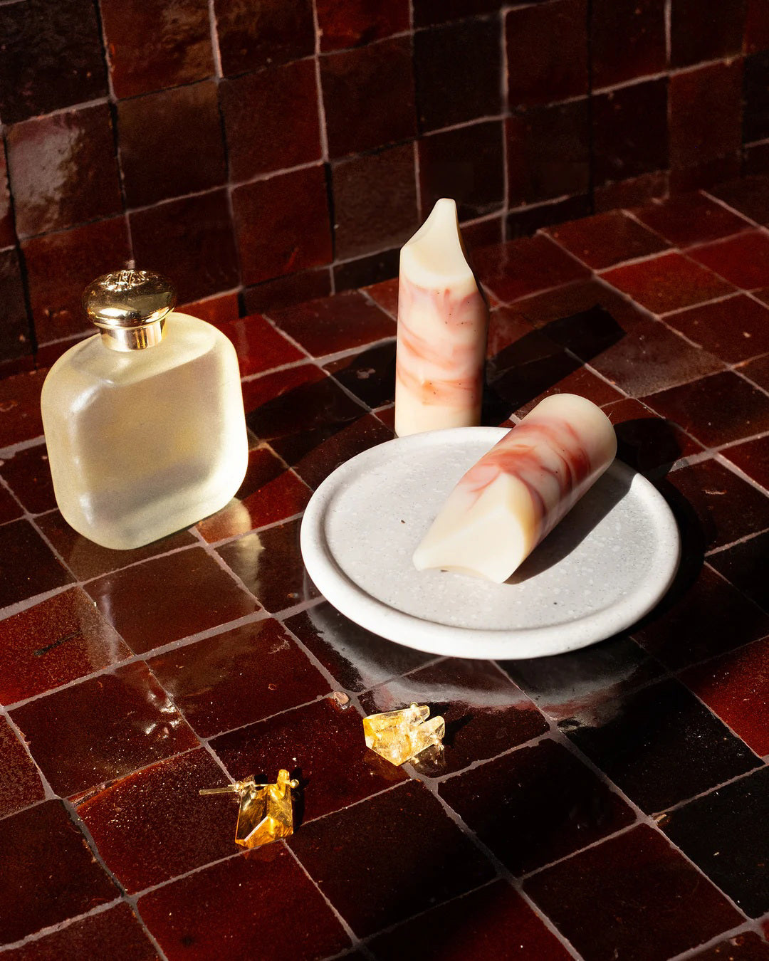 The UME - LAVENDER CREME MINI ERODE SOAP by UME STUDIO is a cylindrical bar with marbled white and brown swirls, standing upright on a white surface. Its top edge is slightly curved and uneven.