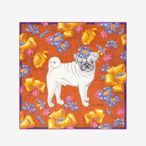 A woman with blonde hair, wearing a tan sweater and the INOUI TOUTOU DOG SCARF IN ORANGE, stands facing the camera against a plain white background.