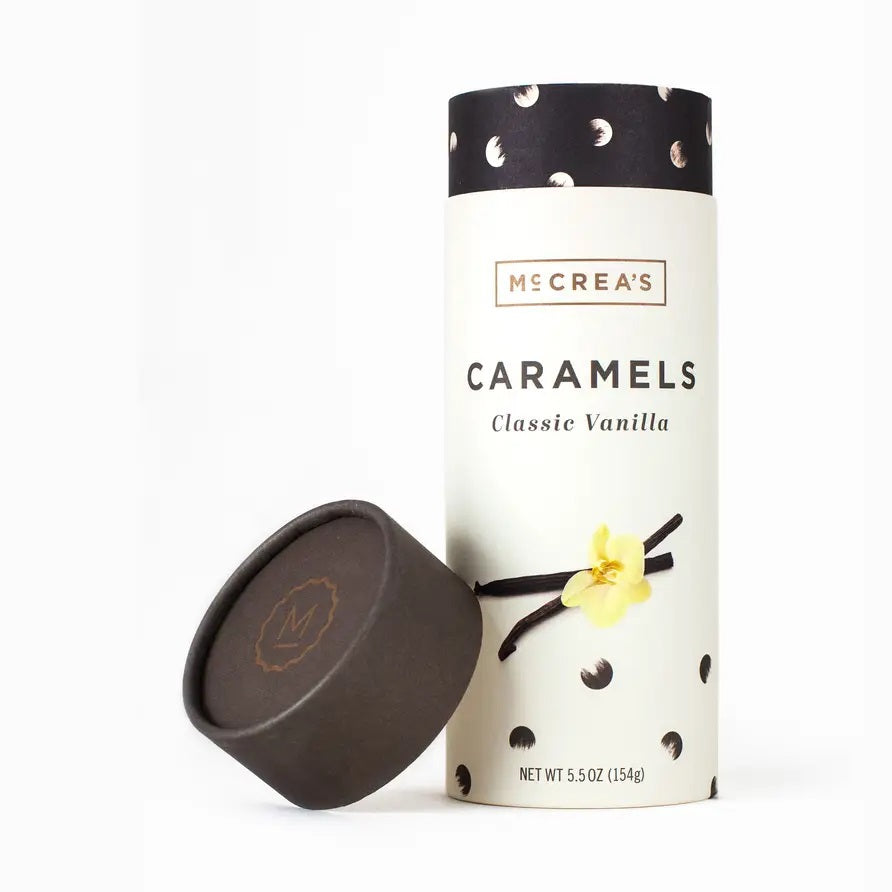 Encased in a cylindrical box with a black lid, McCREA’S CANDIES VANILLA from McCREA’S CANDIES boasts graceful vanilla flower and pod illustrations complemented by black dot accents. These gluten-free vanilla caramels deliver a luxurious, gourmet experience for those with discerning tastes.
