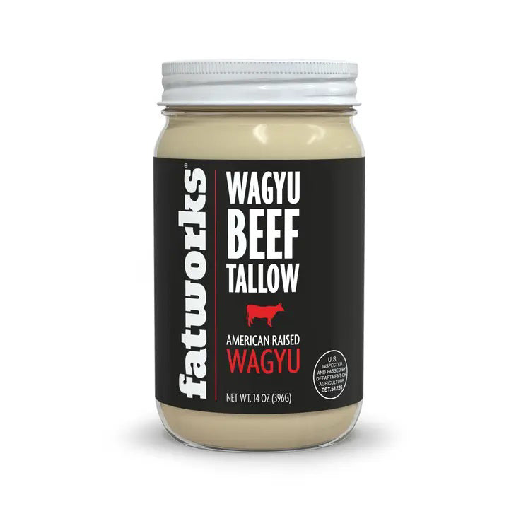 A jar of FATWORKS - AMERICAN WAGYU TALLOW by FATWORKS, with a white lid and black label noting “Wagyu Beef Tallow, American Raised Wagyu,” 14 oz (396g), is ideal for grilling due to its rich monounsaturated fat content.