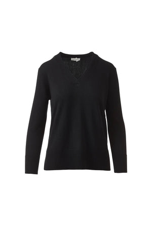 A woman with long brown hair models the KINROSS CASHMERE Hi Low Side Piped Easy Vee Neck Sweater by KINROSS, paired with blue jeans, standing against a plain white background and smiling slightly at the camera.