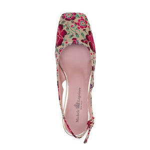 Side view of the MICHELE LOPRIORE - SQUARED SLINGBACK, a single slingback flat shoe with a colorful floral pattern featuring shades of pink, red, green, and blue. This Italian-made shoe has a closed pointed toe, an adjustable gold buckle on the ankle strap, and a small gold heel. It boasts a genuine leather sole for added comfort and durability courtesy of the brand MICHELE LOPRIORE.