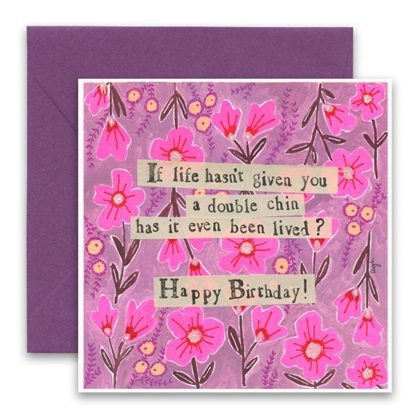 A vibrant birthday greeting card from CURLY GIRL DESIGN, INC features pink and purple flowers on a purple envelope. The CURLY GIRL DESIGNS - DOUBLE CHIN CARD showcases collage art and reads in a playful, mixed-font style: "If life hasn't given you a double chin has it even been lived? Happy Birthday!" reminiscent of the beloved Curly Girl designs.