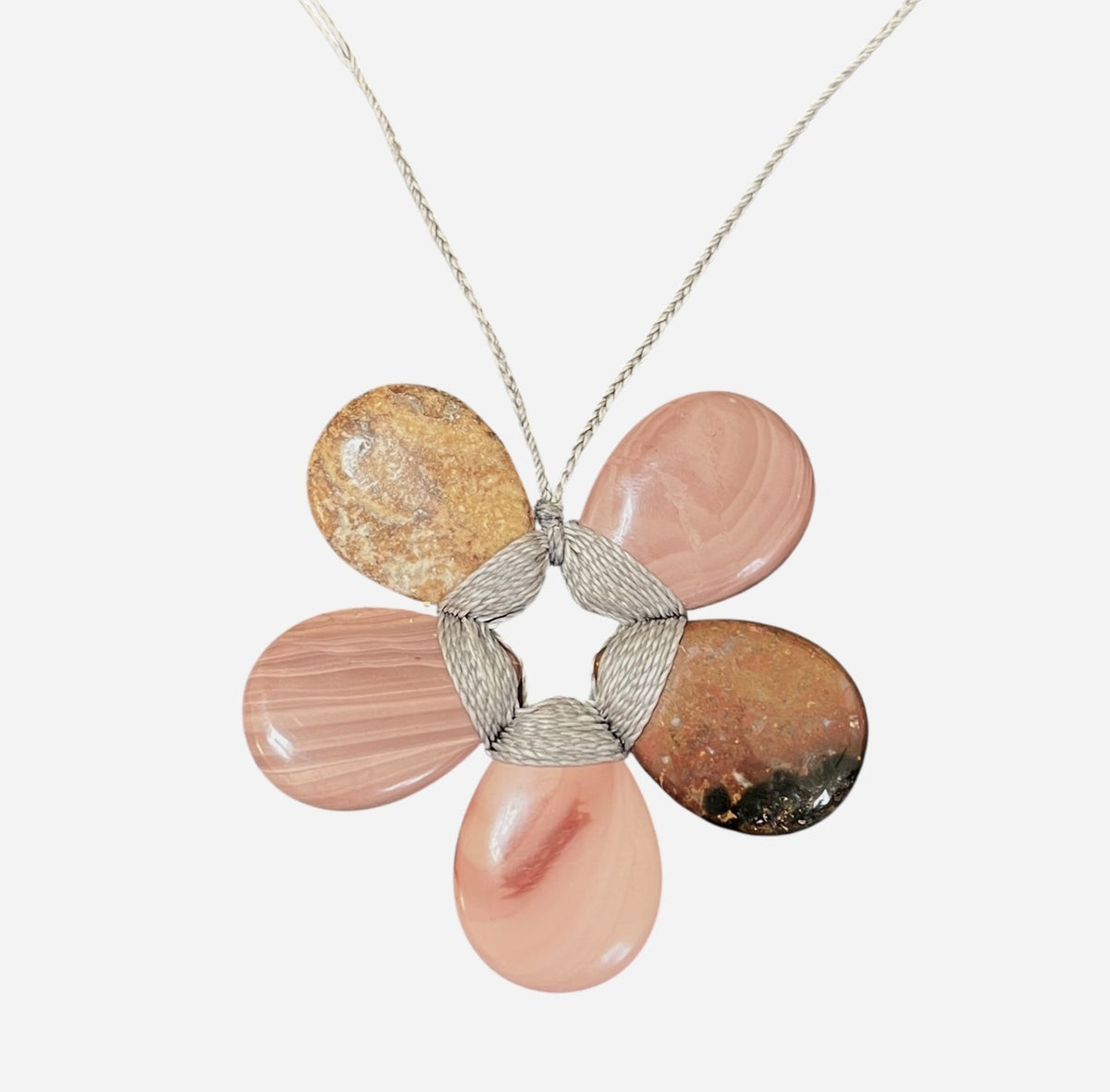 The ANN LIGHTFOOT - MEDIUM MOOKAITE FLOWER NECKLACE features five polished pink and brown mookaite stone petals joined with silver wire, suspended from a thin, adjustable silver chain.