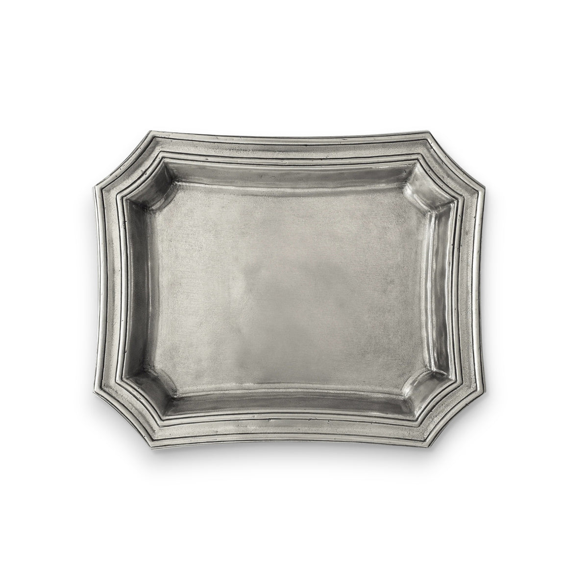 The MATCH - PEWTER POCKET CHANGE TRAY by MATCH, featuring a dark brown base, holds a black leather keychain, three keys, and a small flashlight charm wrapped in green satin ribbon. The tray sits on a dark wood surface.