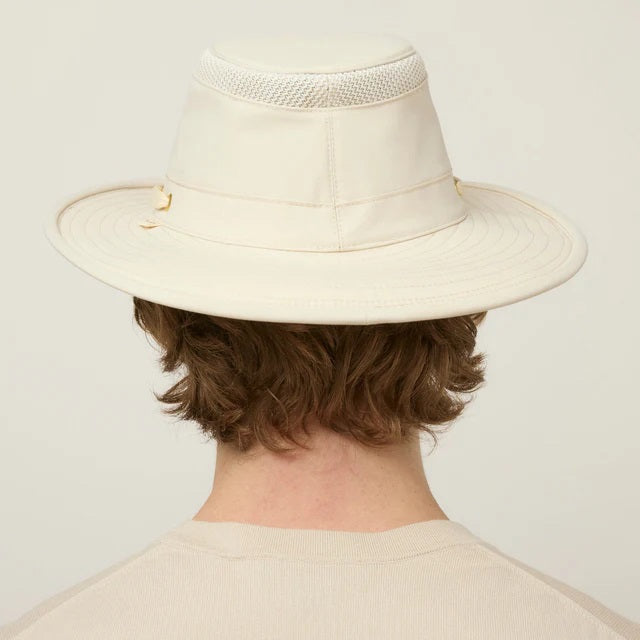 The TILLEY AIRFLO BROAD BRIM HAT LTM6 in Light Stone is a recycled nylon sun hat with UPF 50+ protection, wide brim, mesh ventilation near the crown, and a small band tag. Shown on a plain white background.