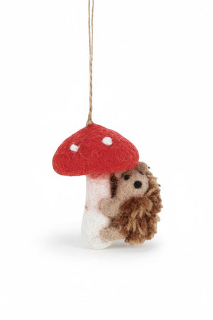 Handmade wool TOADSTOOL HEDGEHOD ORNAMENT featuring a hedgehog hugging a needle felted toadstool with a hanging loop.