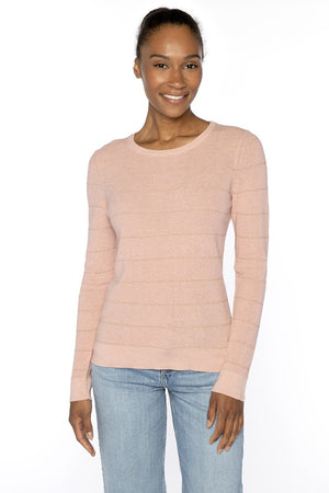 A smiling woman stands against a white background, wearing the KINROSS CASHMERE Thermal Lurez Stripe Crew Neck Sweater in black and light blue jeans.