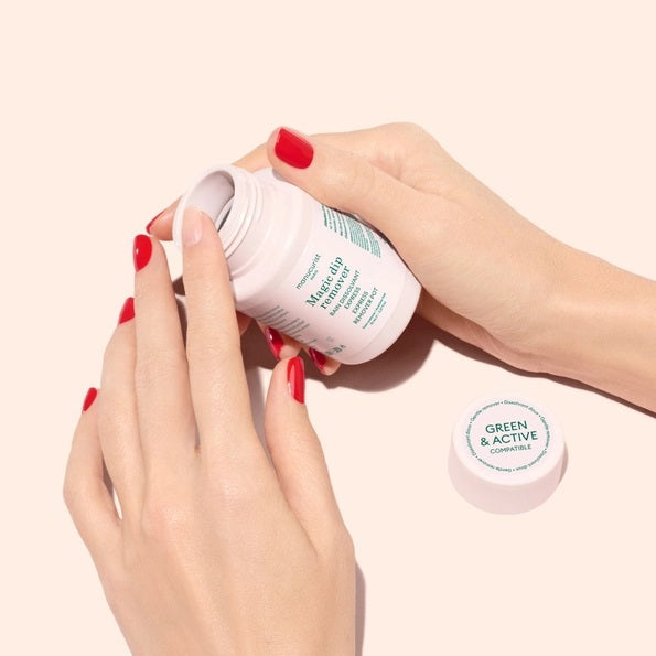 The MANUCURIST - MAGIC DIP REMOVER by MANUCURIST INC comes in a white plastic 70 mL bottle with a screw-on cap, featuring green and pink text on the label. This acetone-free, vegan nail polish remover is designed to gently remove polish and is conveniently travel-friendly for use on the go.