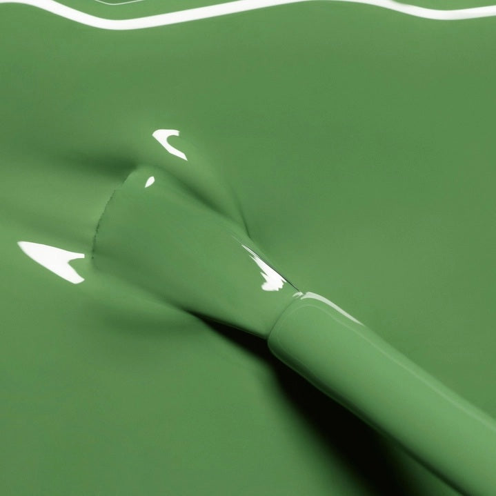 A bottle of MANUCURIST INC GREEN™ Nail Polish in the shade “Artichoke,” a green, quick-dry polish with intense color.