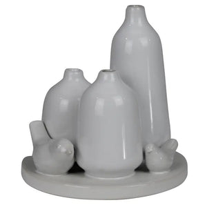 The HOMART CERAMIC VASE TRIO WITH TWO BIRDS features three matte white minimalist vases of varying heights and two bird figurines on a 5.5-inch round base; tallest vase stands 5 inches—ideal for bird vase decor.