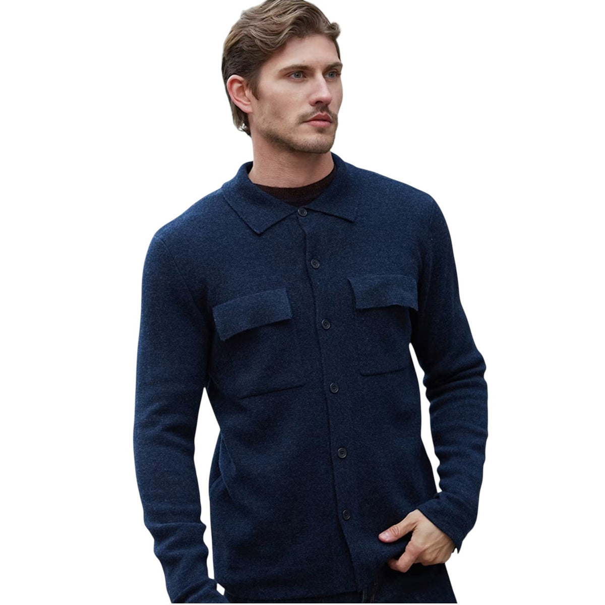 A man wearing the AUTUMN CASHMERE Milano Stitch Shacket in Midnight, featuring two chest pockets, stands with one hand in his pocket and looks to the side against a white background.