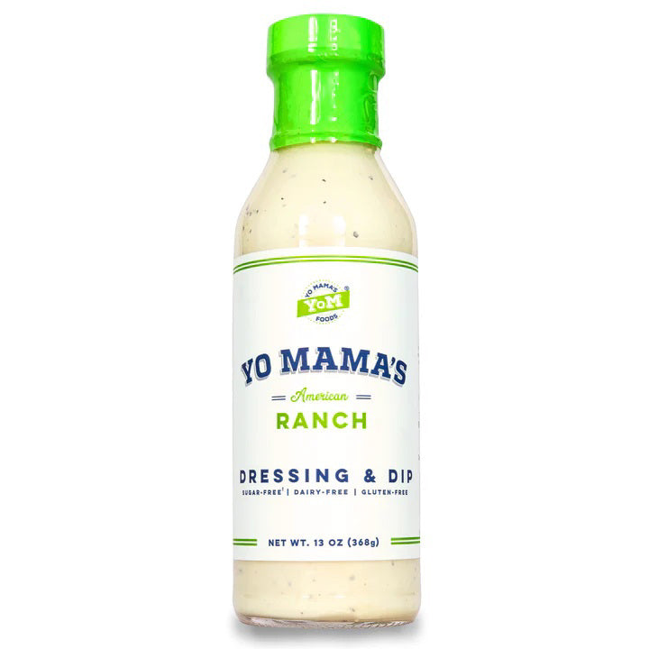 A bottle of YO MAMA'S - AMERICAN RANCH from YO MAMA'S FOODS is displayed against a white background. The green-capped bottle, labeled "dairy-free, gluten-free," and "no sugar added," contains 13 oz (368g) of hand crafted Ranch Dressing &amp; Dip.