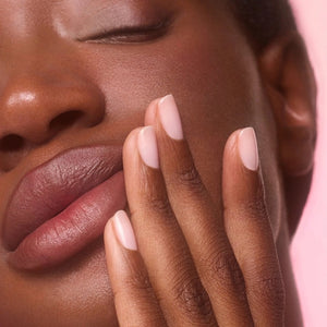 Three close-up photos of a fingernail: first, bare; second, after one coat of MANUCURIST - ACTIVE™ BLUR TREATMENT POLISH in a powder-pink shade (appearing slightly shinier); and third, after two coats (showing even glossier and smoother results). Each stage is clearly labeled to highlight the transformation, perfect for fans of MANUCURIST INC vegan nail care solutions.