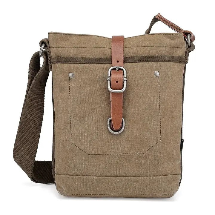 The TSD BRAND - FOREST ZIP CROSSBODY BAG IN OLIVE is a military-inspired khaki canvas bag with a front pocket, brown adjustable strap, decorative leather buckle, metal rivets, and textured shoulder strap for style and durability.