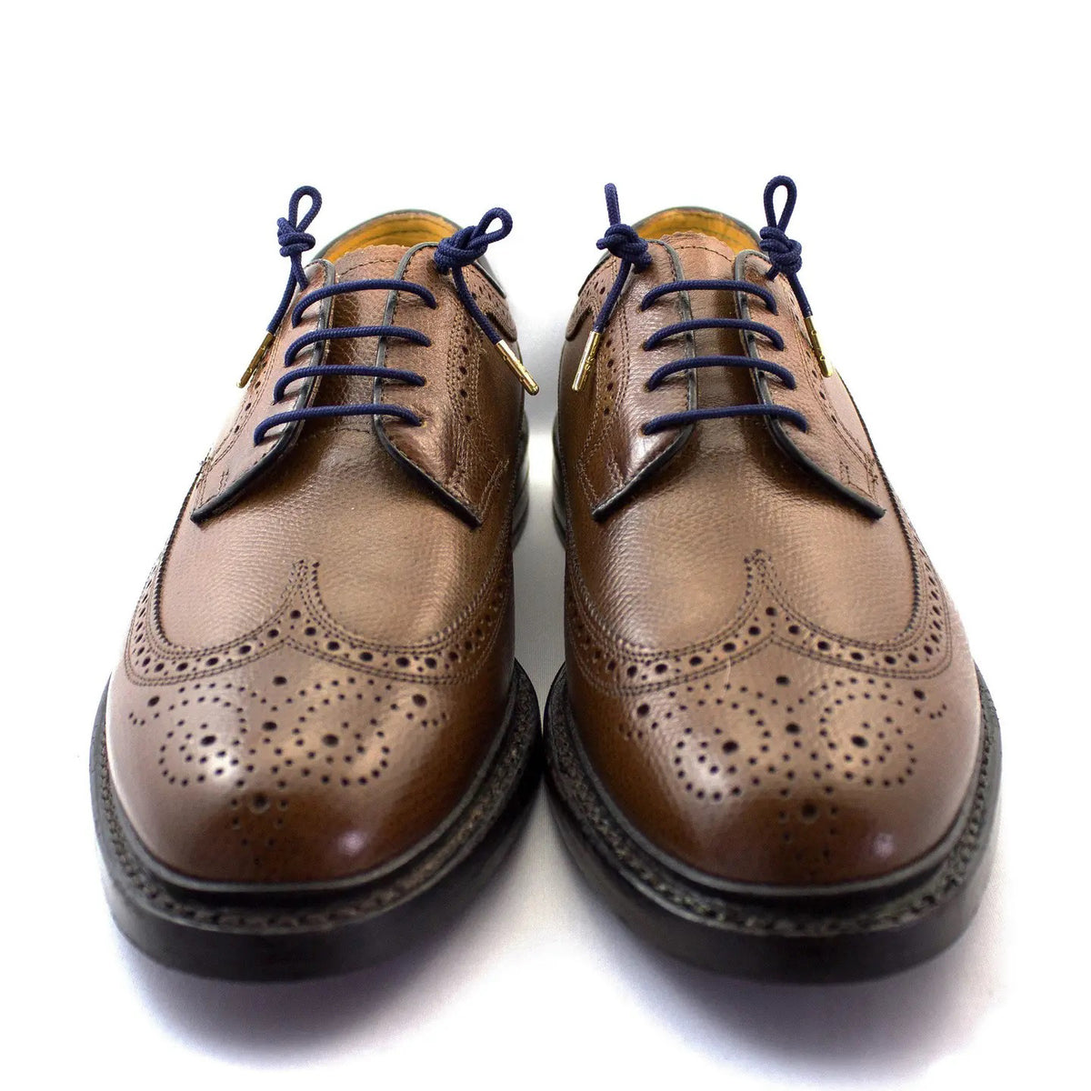 The STOLEN RICHES Dress Shoelace in Mission Blue features premium navy laces with gold metal tips, bundled and secured by a white band labeled "Stolen Riches - Since 1915" with a crown logo.