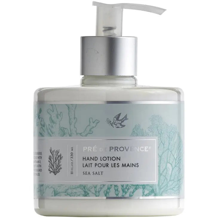 A pump bottle of EUROPEAN SOAPS, LLC's HERITAGE LOTION - SEA SALT, this deeply moisturizing hand lotion comes in an 11 fluid ounce (330 ml) light blue and white bottle adorned with bird and seaweed illustrations. Infused with shea butter for a silky-smooth feel, the lotion features text in both English and French.