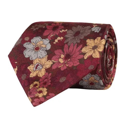 Expertly crafted by AMANDA CHRISTENSEN, the FLORAL SILK TWILL TIE IN WINE RED MELANGE features a sophisticated maroon hue adorned with a floral pattern in yellow, pink, and white flowers with green leaves. This luxurious silk tie is a quintessential piece of classic European menswear and an essential addition to any refined collection of men’s accessories.