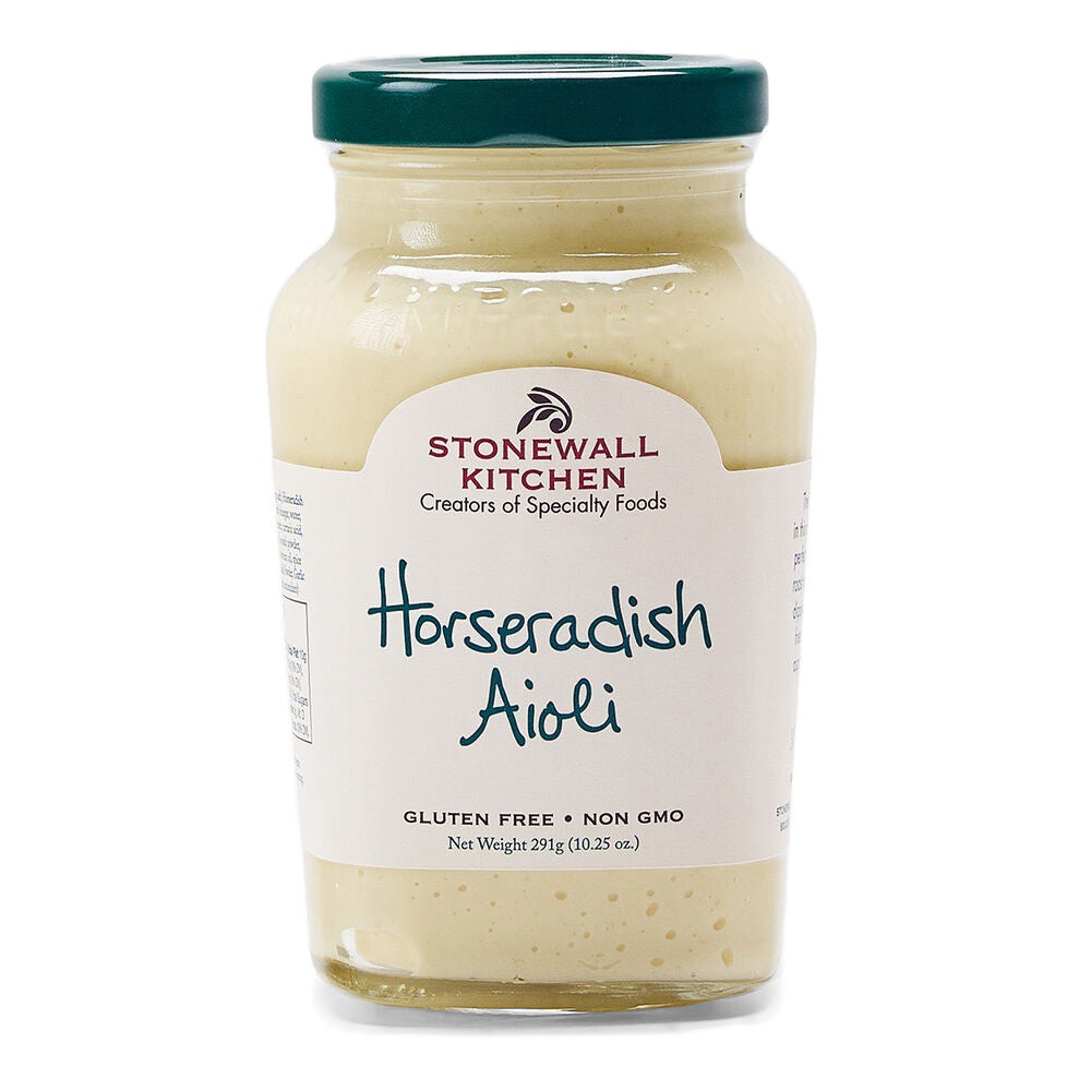 A jar of STONEWALL KITCHEN-HORSERADISH AIOLI with a green lid. The label reads "STONEWALL KITCHEN, Creators of Specialty Foods," "Horseradish Aioli," "Gluten Free," and "Non GMO." With a net weight of 219 grams (7.7 ounces), this creamy, pale sauce is perfect for roast beef sandwiches or French fries.