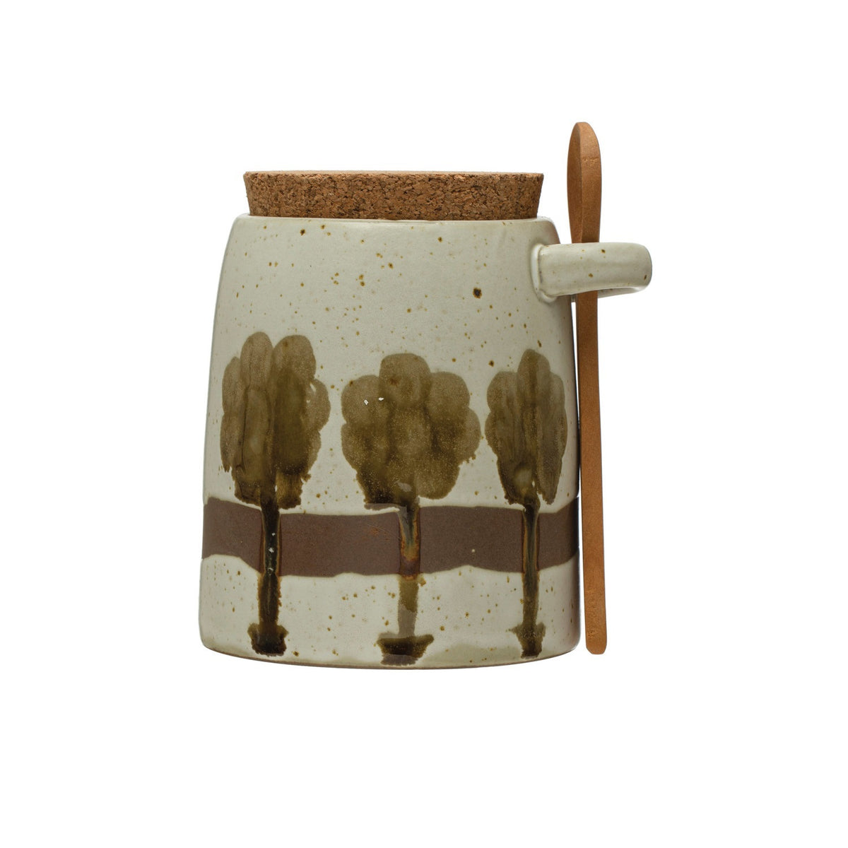 The CREATIVE COOP Hand-Painted Stoneware Jar features a green tree design, cork lid, and wood spoon. Perfect for kitchen storage. Measures 4.25" tall x 3.25" wide.
