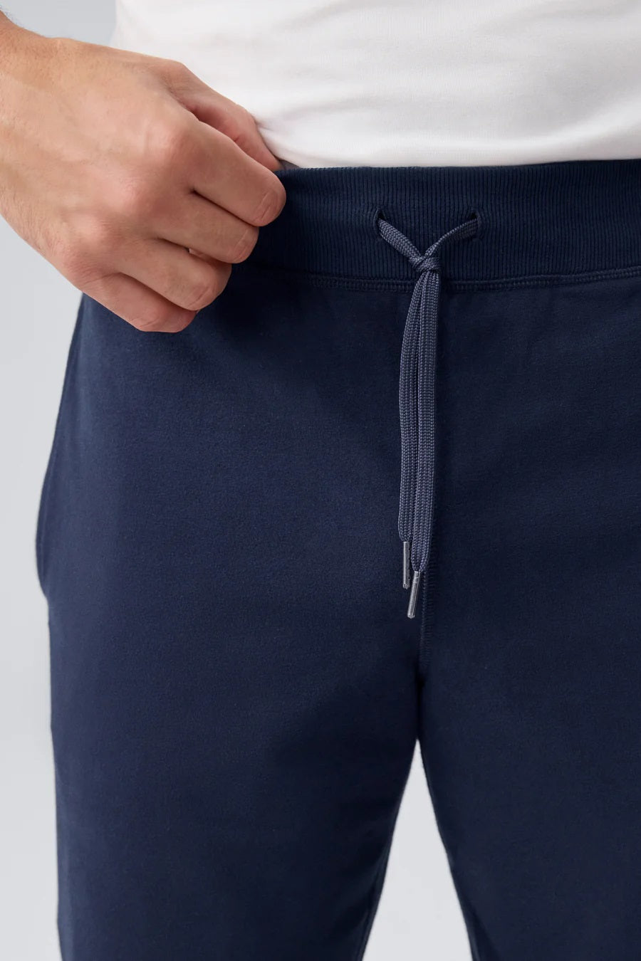 The MACK WELDON Ace Relaxed Fit Sweatpants in True Navy - Bird’s Eye feature a soft, slightly heathered French terry fabric, elastic waistband with drawstring, ribbed cuffs, relaxed fit, and a small embroidered logo on the left thigh.