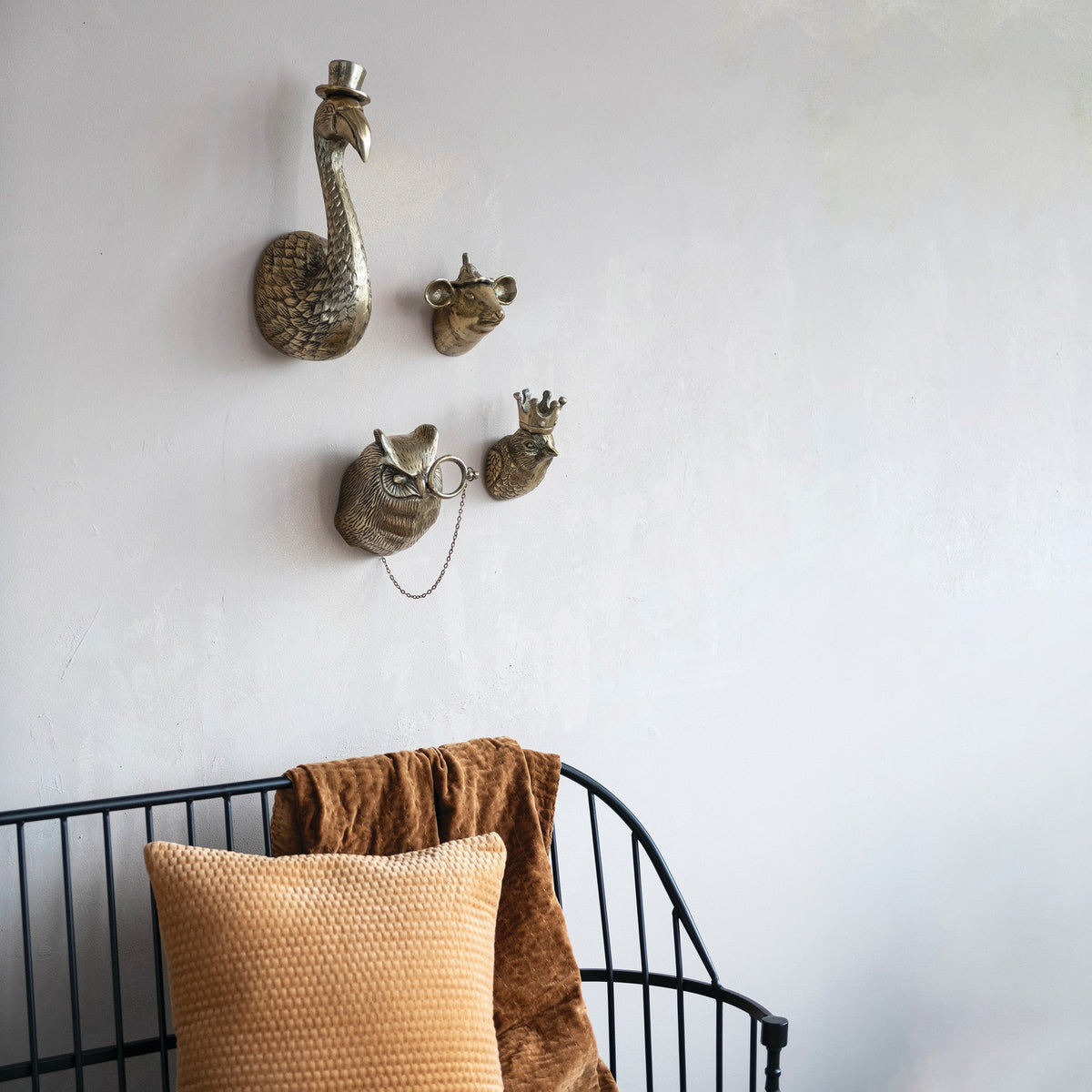 The CREATIVE COOP MOUSE HEAD WITH HAT WALL DÉCOR features an antique brass finish and is a whimsical mouse sculpture with large ears and a pointy hat, perfect as charming wall décor for your home.