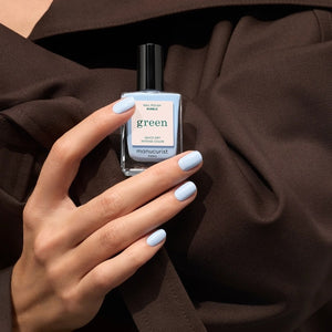 A bottle of MANUCURIST - GREEN™ Nail Polish in Bubble by MANUCURIST INC, featuring a blue and cream label with “Quick Dry Intense Color” and a black cap.