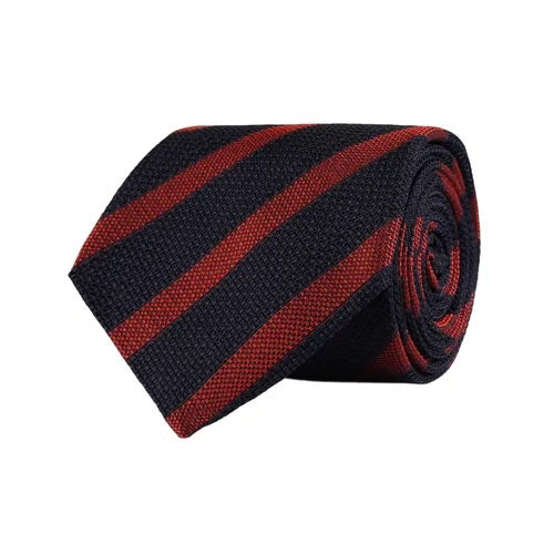 A close-up of the AMANDA CHRISTENSEN - STRIPED JACQUARD WOVEN SILK TIE IN RUST reveals its elegant red diagonal stripes on luxurious Italian silk, with a label bearing the AMANDA CHRISTENSEN name against a white background—an exceptional men’s formal accessory perfect for any refined occasion.