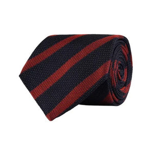 A close-up of the AMANDA CHRISTENSEN - STRIPED JACQUARD WOVEN SILK TIE IN RUST reveals its elegant red diagonal stripes on luxurious Italian silk, with a label bearing the AMANDA CHRISTENSEN name against a white background—an exceptional men’s formal accessory perfect for any refined occasion.