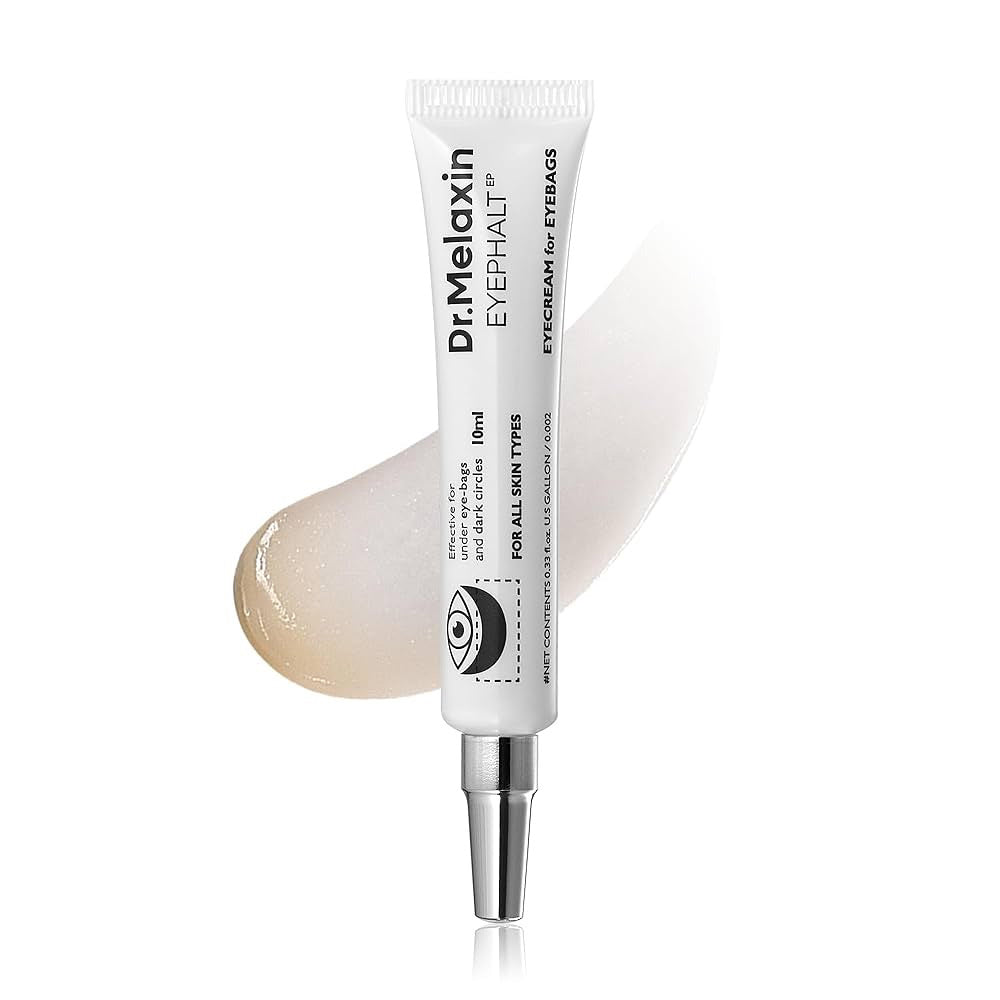 A white tube labeled &quot;DR MELAXIN - EYEPHALT EYEBAG CREAM&quot; from KOSMIC KBEAUTY SKINCARE, with a silver applicator tip, is displayed in front of a smear of cream on a white background.
