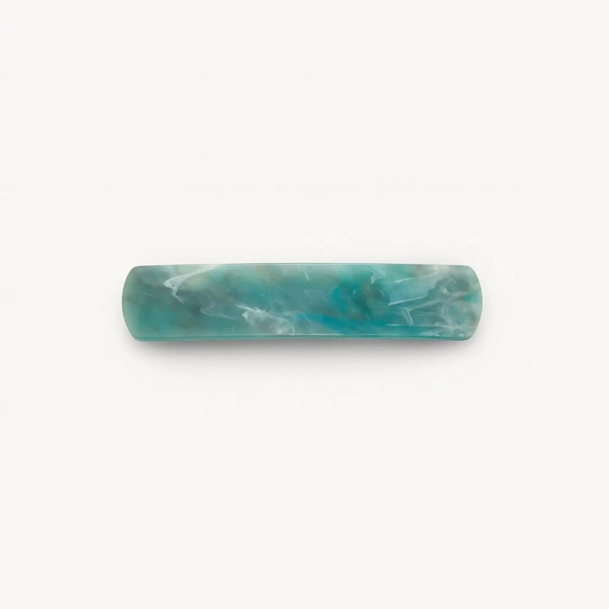 The MACHETE - NO. 3 Heirloom Barrette in Jadeite by MACHETE features a rectangular, rounded-edge handmade design in marbled blue-green cellulose acetate with white streaks, shown on a plain white background.