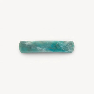 The MACHETE - NO. 3 Heirloom Barrette in Jadeite by MACHETE features a rectangular, rounded-edge handmade design in marbled blue-green cellulose acetate with white streaks, shown on a plain white background.