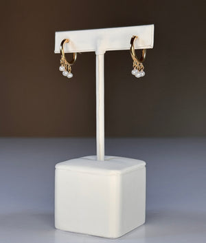 GOLDISH - FRINGE HOOP EARRINGS WITH WHITE PEARLS by GOLDISH: small gold fill hoops featuring three dangling white pearl charms, shown on a plain white background.