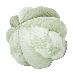 The LAMBWOLF COLLECTIVE - TOTO SILENT SNUFFLE BALL DOG TOY is a soft, light green plush ball crafted from various textured fabric segments stitched together in a flower-like or abstract shape.