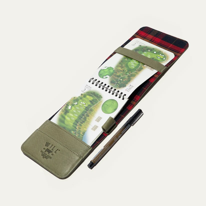The WILL LEATHER GOODS - GOLF YARDAGE BOOK IN GREEN lies open with a black and brown pen in front, displayed on a plain white background.