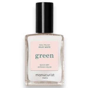 A hand adorned with MANUCURIST - GREEN™ NAIL POLISH IN MILKY WHITE by MANUCURIST INC rests on a soft yellow leather purse, set against a backdrop of cream-colored textured fabric.