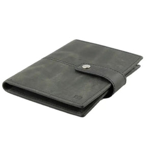 The GARZINI RFID-blocking leather passport holder in black features an AirTag compartment and snap button closure, shown on a white background.