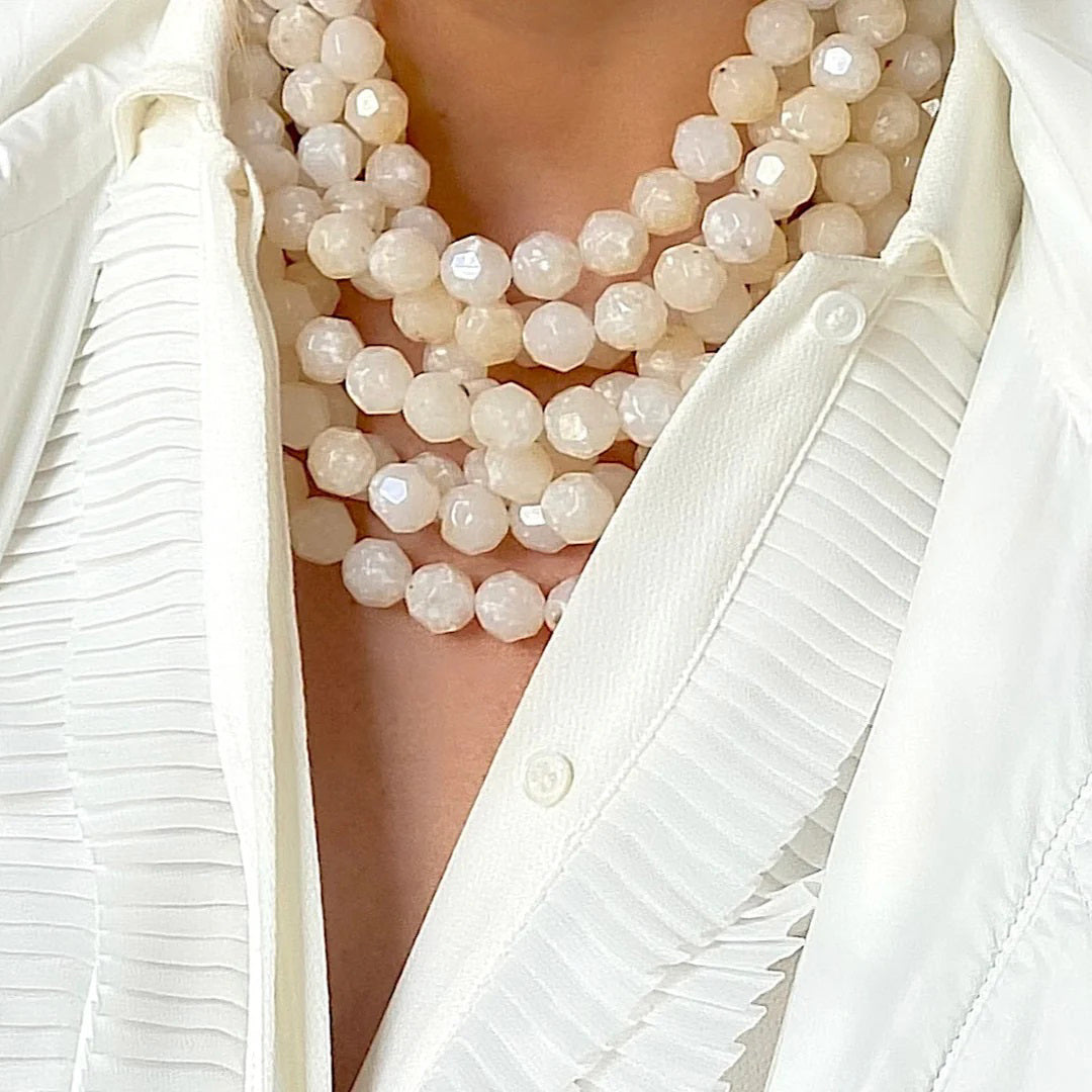 The FAIRCHILD BALDWIN - THE BELLA NECKLACE showcases layered strands of iridescent green Italian resin beads with a faceted design for a shimmering effect, finished with a smooth light green clasp that complements its vibrant hues.