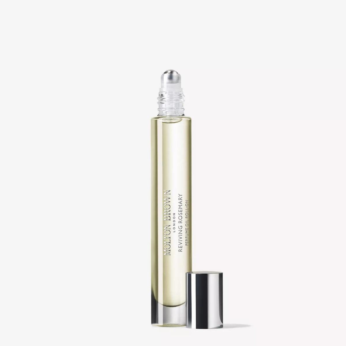 A clear glass rollerball bottle filled with pale yellow liquid, labeled "MOLTON BROWN REVIVING ROSEMARY TRAVEL PERFUME OIL .33FLOZ," stands upright with its shiny silver cap beside it on a plain white background.