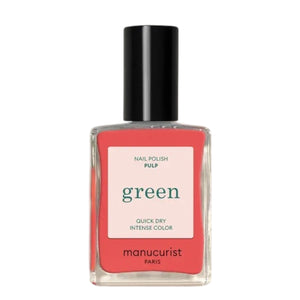 A bottle of MANUCURIST INC’s GREEN™ Nail Polish in the shade “Pulp,” showcasing a vibrant coral hue, with a sleek black cap and a label that reads “green quick dry intense color,” made using bio-sourced ingredients.