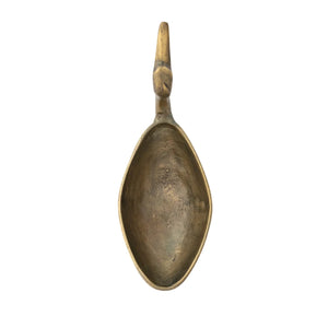 The CREATIVE COOP BIRD SHAPED BOWL IN ANTIQUE BRASS FINISH features an elongated neck and beak forming the handle, with the body as the bowl, creating a unique decorative accent.