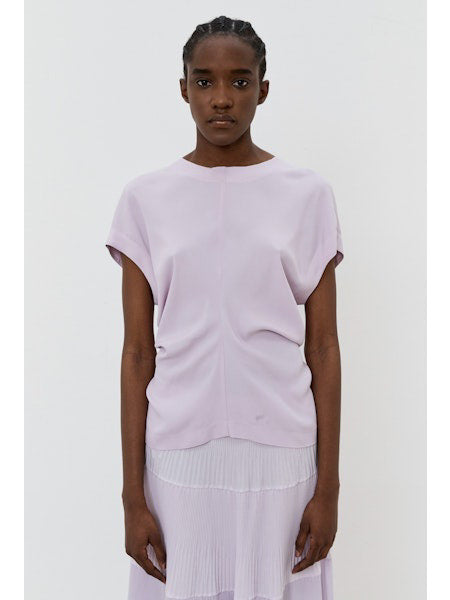 The image portrays a solid black square with a textured, slightly uneven surface. With subtle shading variations, it seems to be a photograph perfectly capturing the minimalist essence of the MEIMEIJ - CAP SLEEVE TOP from the MEIMEIJ brand.