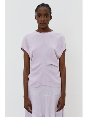 The image portrays a solid black square with a textured, slightly uneven surface. With subtle shading variations, it seems to be a photograph perfectly capturing the minimalist essence of the MEIMEIJ - CAP SLEEVE TOP from the MEIMEIJ brand.