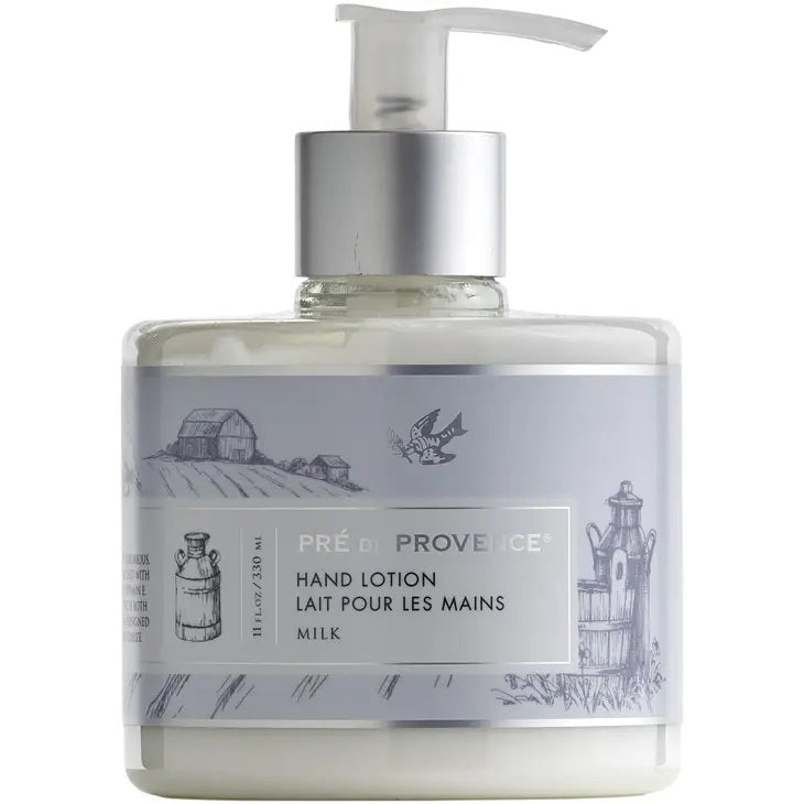A 10 fluid ounce (300 ml) bottle of European Soaps, LLC Heritage Lotion - Milk with a pump dispenser. The label reads "Hand Lotion Lait Pour Les Mains Milk" and features sketches of fields, a barn, a milk can, and a windmill. Enriched with shea butter and vitamin E, this lotion nourishes and softens your skin.