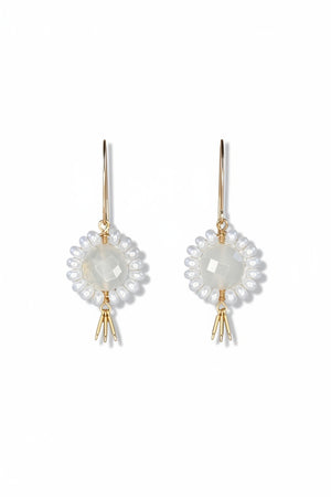 The GOLDISH - Floral Gemstone Earrings in Moonstone and White Pearl feature a circular, faceted moonstone center surrounded by white pearls, with three gold danglers, all set in 14K gold fill. Displayed on a white stand against a dark background.