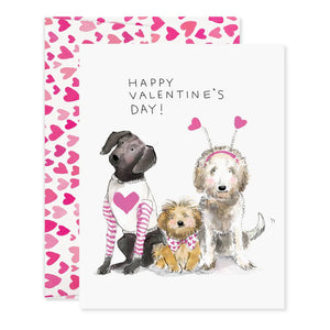 The E. FRANCES PAPER - DOGGIE DRESS-UP CLASSROOM VALENTINE SET features three dogs dressed festively: one in striped pajamas, another with a heart bandana, and a third with heart antennae. “Happy Valentine’s Day!” is displayed across the top against a backdrop of pink hearts, ideal for charming Valentines or envelopes.