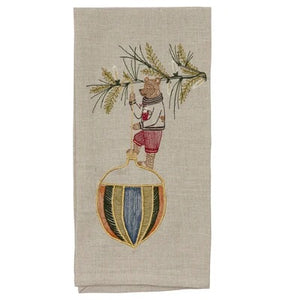 DECK THE HALLS BEAR LINEN TEA TOWEL featuring a bear in a sweater hanging a large, colorful, striped Christmas ornament from a pine branch on natural flax fiber.