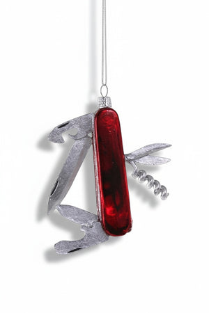 A 3.5-inch GLASS SWISS ARMY KNIFE ORNAMENT by Cody Foster, shaped like a multi-tool pocket knife with a red handle and silver folded blades.