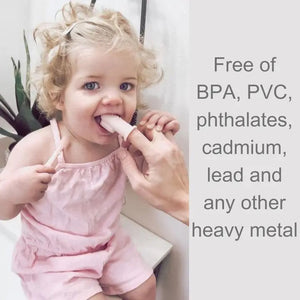 A child with curly blonde hair in a pink outfit is seated, holding a light-colored popsicle with the assistance of an adult's hand. Text on the right side of the image reads: "Free of BPA, PVC, phthalates, cadmium, lead and any other heavy metal," highlighting the importance of safe materials for good oral hygiene using the SILICONE FINGER TOOTHBRUSH AND TONGUE CLEANER by ALI + OLI.